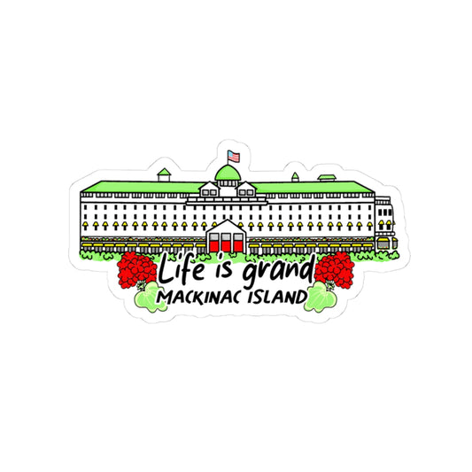 A die-cut sticker featuring a grand hotel of the Mackinac Island Statehouse with the text 'Life is grand MACKINAC ISLAND' and red raspberries, shown on a plain white background.