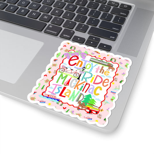 A colorful die-cut sticker with the text 'End the Ride Muckinac Island' and small travel-themed illustrations, shown placed on a silver laptop keyboard.