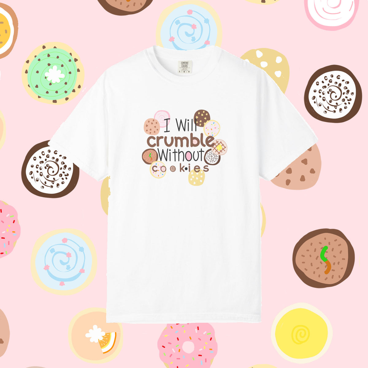 Crumbl Cookie lovers white short-sleeve t-shirt with a cute graphic that reads 'I will crumble without cookies' surrounded by illustrated donuts, set against a pink background patterned with donuts.