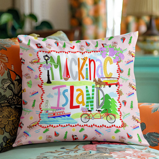 cutest christmas gifts from Mackinac island square decorative throw pillow featuring a colorful 'Mackinac Island' design on a light pink background, styled on a floral sofa in a living room setting.