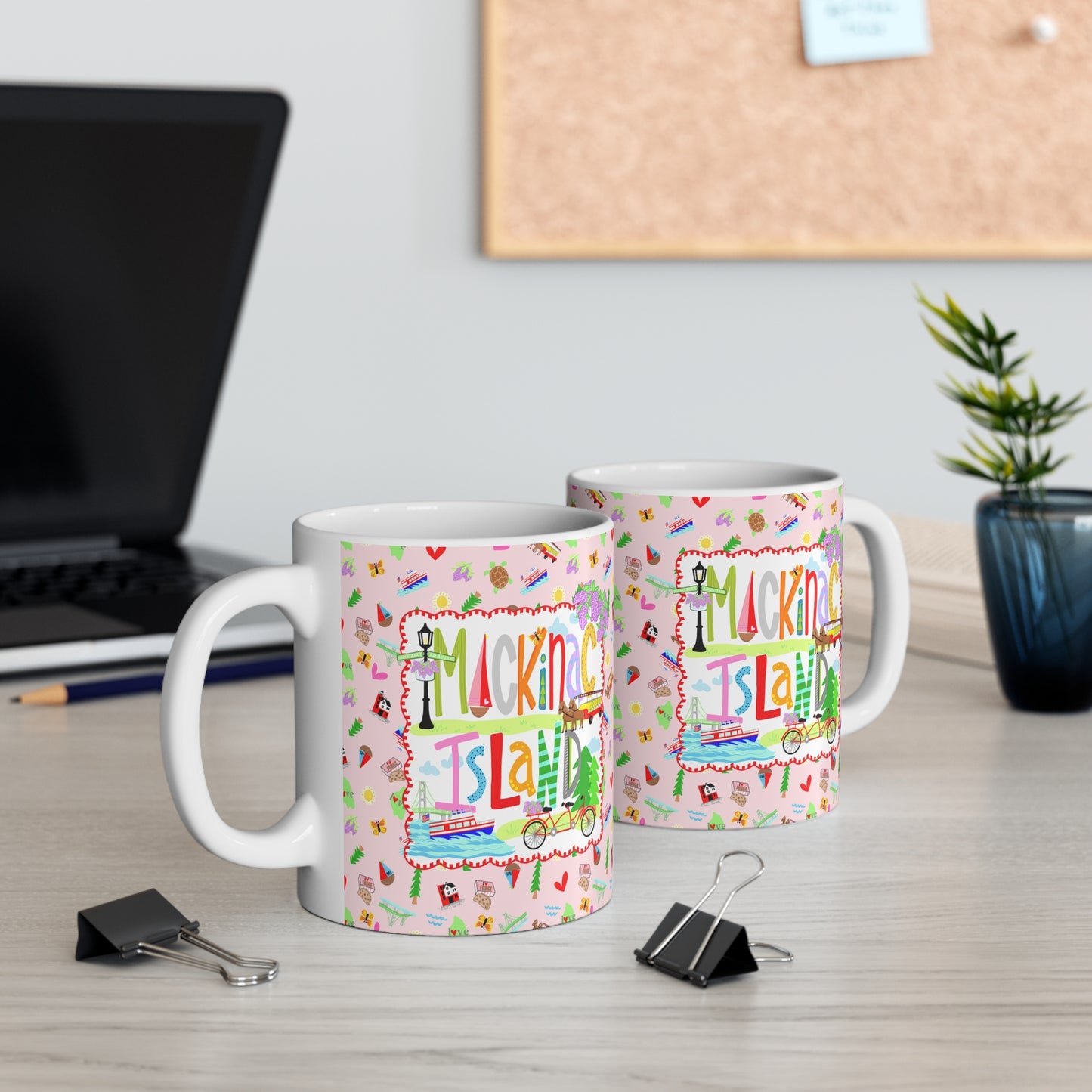 Double the Mackinac Island charm! This image showcases two ceramic mugs displayed on a desk, highlighting the vibrant bicycle artwork printed on both sides. Whether you're left- or right-handed, the colorful design is always on display. A perfect Michigan souvenir, thoughtful Mackinac Island gift, or everyday coffee mug for anyone who loves the island's timeless beauty and bicycle-filled streets.