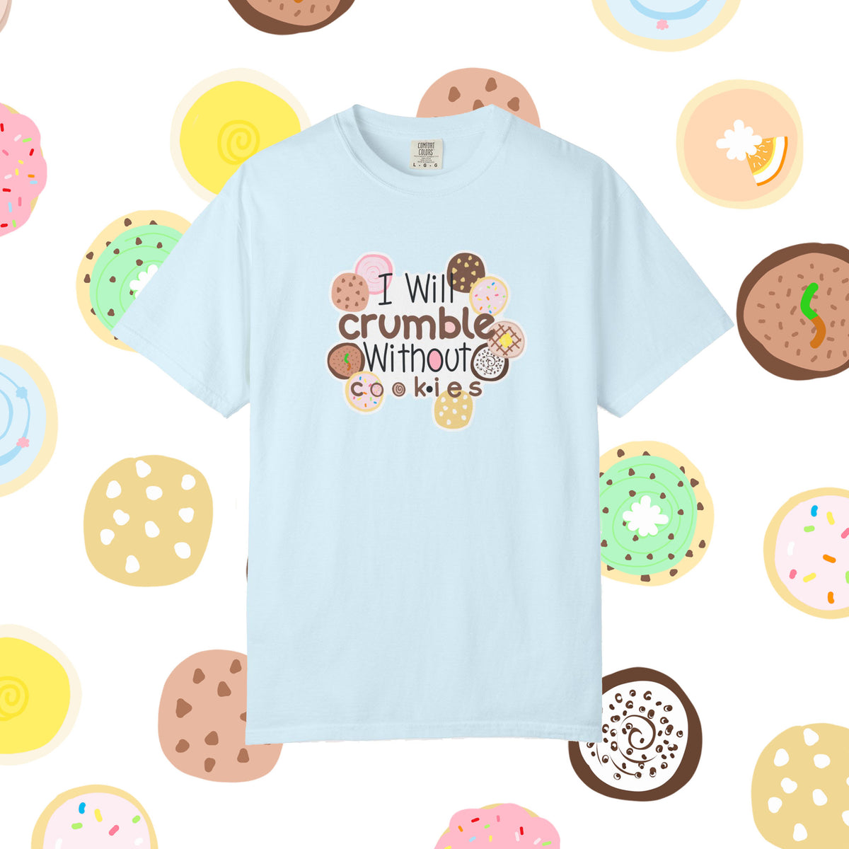 A light blue short-sleeve t-shirt with a graphic that reads 'I Will crumble Without cookies' surrounded by various illustrated donuts and cookies, displayed on a white background with a matching donut pattern.